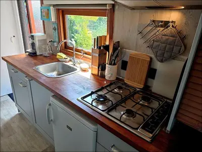 a kitchen with a stove and a sink at Apartment Het kleine Hemeltje by Interhome in Wervershoof