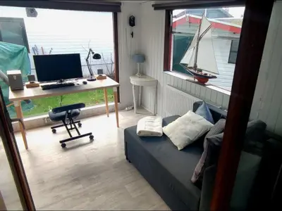 a room with a desk with a computer and a bed at Apartment Het kleine Hemeltje by Interhome in Wervershoof