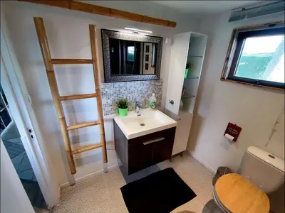 a bathroom with a sink and a mirror at Apartment Het kleine Hemeltje by Interhome in Wervershoof
