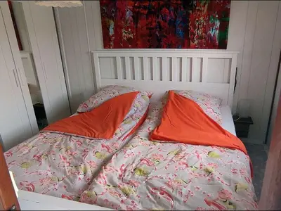 a bed with two pillows on top of it at Apartment Het kleine Hemeltje by Interhome in Wervershoof