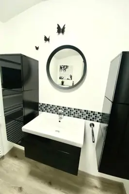 a bathroom with a sink and a mirror at Holiday Home Luna by Interhome in Wervershoof