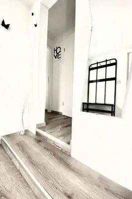 a room with white walls and a wooden floor at Holiday Home Luna by Interhome in Wervershoof