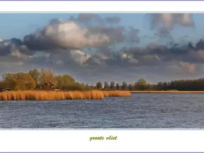 a view of a large body of water with grass at Holiday Home Luna by Interhome in Wervershoof