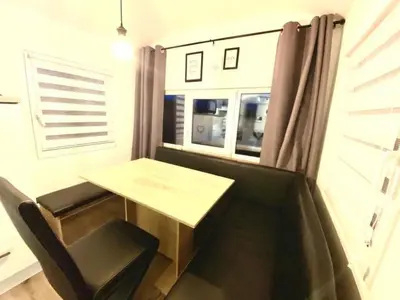 a small table and chair in a room with a window at Holiday Home Luna by Interhome in Wervershoof