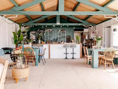 a patio with tables and chairs and a bar at Holiday Home Strandhaus direkt am Meer by Interhome in Wijk aan Zee