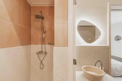a bathroom with a shower with a sink and a tub at Cozy Traditional Dutch City Apartment close to Amsterdam & Tulips in Purmerend