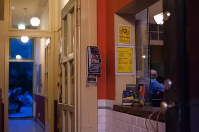 a man sitting at a counter in a fast food restaurant at Strowis Hostel in Utrecht
