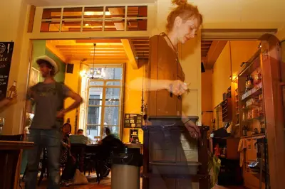 a man and a woman standing in a kitchen at Strowis Hostel in Utrecht