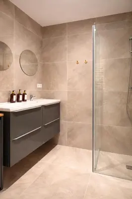 a bathroom with a sink and a shower at Alkmaar Signature Stay -Boutique Apartment in Alkmaar
