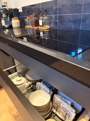 a kitchen with a counter with toilets and plates at Alkmaar Signature Stay -Boutique Apartment in Alkmaar