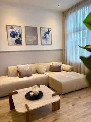 a living room with a couch and a table at Alkmaar Signature Stay -Boutique Apartment in Alkmaar