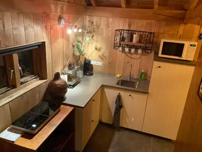 a small kitchen with a counter and a sink at B&B Tuinhuis Vianen in Vianen