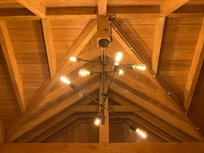 a chandelier is hanging from a wooden ceiling at B&B Tuinhuis Vianen in Vianen