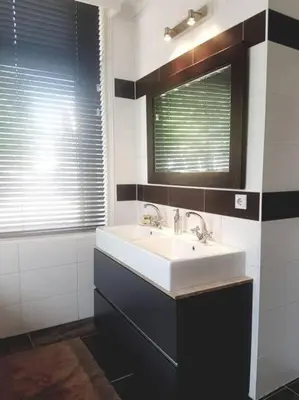 a bathroom with a sink and a mirror at Unique B&B, in the Historic City Centre of Edam in Edam