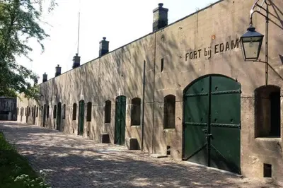 a building with a green door on the side of it at Unique B&B, in the Historic City Centre of Edam in Edam