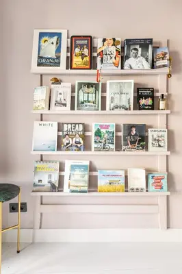 a book shelf filled with books at Canal house Egelantiersgracht with private garden in Amsterdam