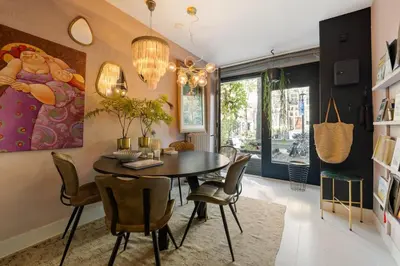 a dining room with a table and chairs at Canal house Egelantiersgracht with private garden in Amsterdam