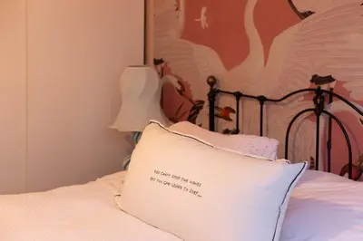 a bed with a pillow with a sign on it at Canal house Egelantiersgracht with private garden in Amsterdam