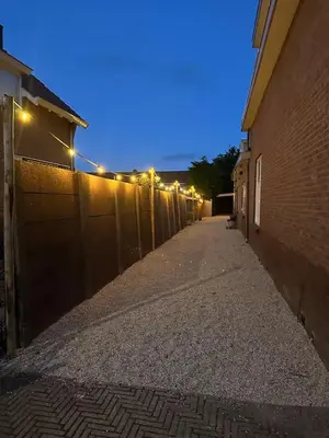 an empty alley with lights on the side of a building at Little Village - Noordwijkerhout in Noordwijkerhout