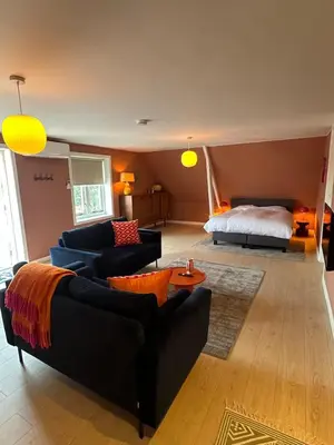 a living room with two couches and a bed at Little Village - Noordwijkerhout in Noordwijkerhout