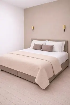 a large bed with white sheets and pillows at Maison Lumière - Private Rooftop terrace in Amsterdam