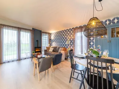 a living room with a couch and a table at Bij de Bakker in Oud-Ade