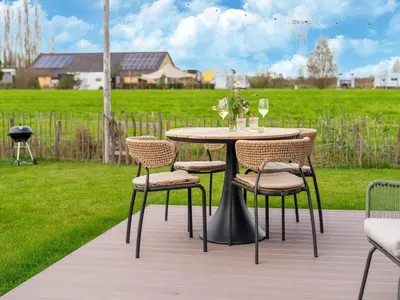 a table and chairs on a wooden deck at Bij de Bakker in Oud-Ade