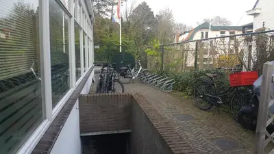 a group of bikes parked outside of a house at Zorn Hotel Duinlust in Noordwijk aan Zee
