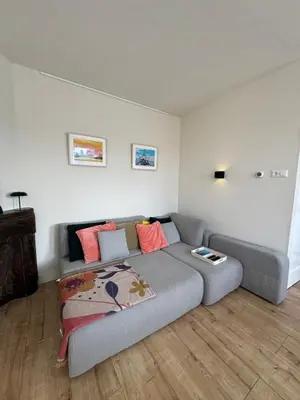 a living room with a couch and a bed at Authentic sunny Amsterdam Jordaan apartment in Amsterdam