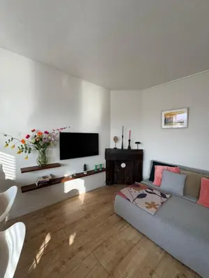 a living room with a couch and a flat screen tv at Authentic sunny Amsterdam Jordaan apartment in Amsterdam