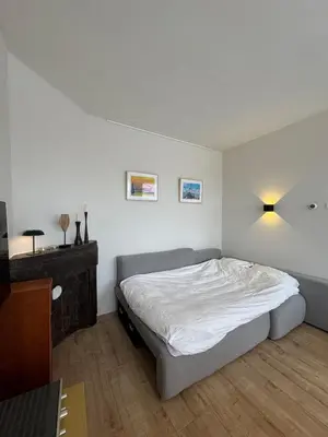 a bedroom with a bed and a dresser in it at Authentic sunny Amsterdam Jordaan apartment in Amsterdam