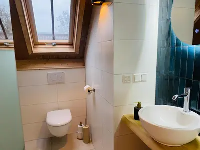 a bathroom with a sink and a toilet at De Wagenloods in Alphen aan den Rijn