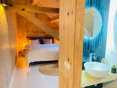 a bedroom with a bed and a sink at De Wagenloods in Alphen aan den Rijn