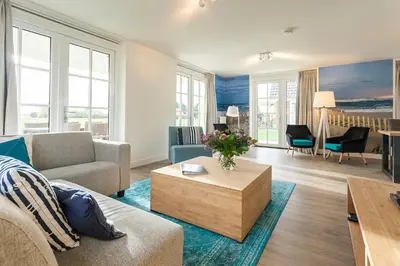 a living room with a couch and a coffee table at Buitenplaats Witte Raaf aan Zee in Noordwijk