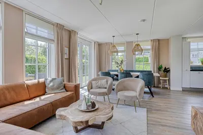 a living room with a couch and a table at Buitenplaats Witte Raaf aan Zee in Noordwijk