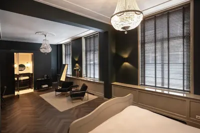 a living room with black walls and a chandelier at Steenhof Residence Warmond in Warmond