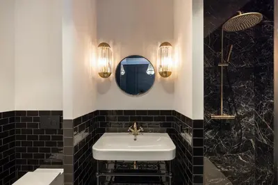 a bathroom with a white sink and a mirror at Steenhof Residence Warmond in Warmond