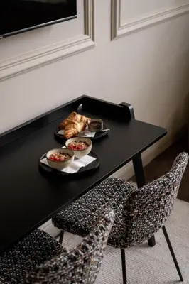 a black table with two bowls of food and two chairs at Steenhof Residence Warmond in Warmond