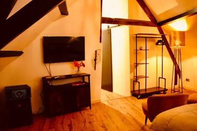 a living room with a flat screen tv on the wall at Herberg De Hollandsche Leeuw in Nieuwkoop