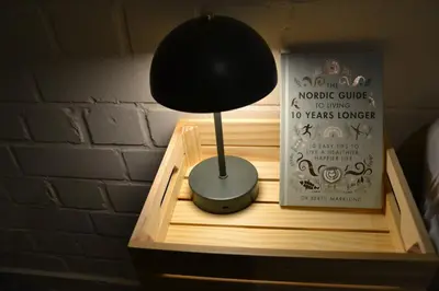 a black lamp sitting on top of a wooden shelf at Nature and tranquility in Soest with Forest, Dunes and City in Soest