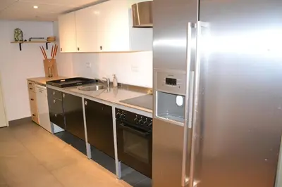 a kitchen with a stainless steel refrigerator and a sink at Nature and tranquility in Soest with Forest, Dunes and City in Soest