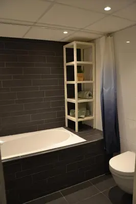 a bathroom with a bath tub and a toilet at Nature and tranquility in Soest with Forest, Dunes and City in Soest