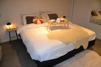 a bedroom with a bed with a table on it at Nature and tranquility in Soest with Forest, Dunes and City in Soest