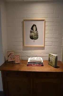 a table with books and a picture on a wall at Nature and tranquility in Soest with Forest, Dunes and City in Soest