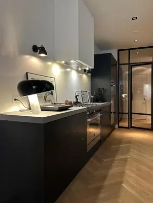 a kitchen with black cabinets and a counter top at The Design apartment with canal-view in Amsterdam