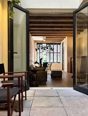 an open door to a room with a living room at The Design apartment with canal-view in Amsterdam