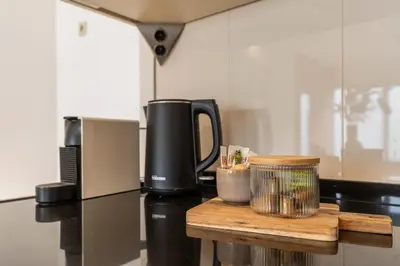 a counter top with a coffee maker and a microwave at Appartement de Burgemeester - centrum in Castricum