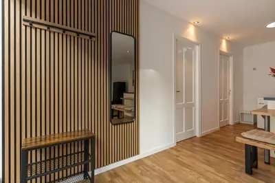 a mirror on a wall in a room with a bench at Appartement de Burgemeester - centrum in Castricum