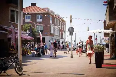 a group of people walking down a city street at Logies at the sea in Katwijk aan Zee