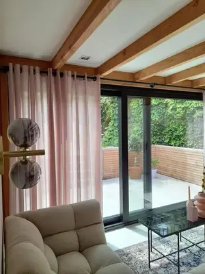 a living room with a couch and a glass table at Logies at the sea in Katwijk aan Zee
